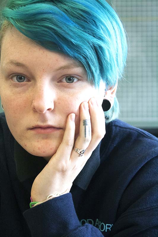 Junior Katie Crow has eleven tattoos, seven of which she has applied to herself with a needle and the ink of a permanent marker, later transitioning to using Indian ink. Pictured are a heart on her hand, which reminds her of friendship, the feminist symbol on her middle finger, and seven lines for good luck on her ring finger.