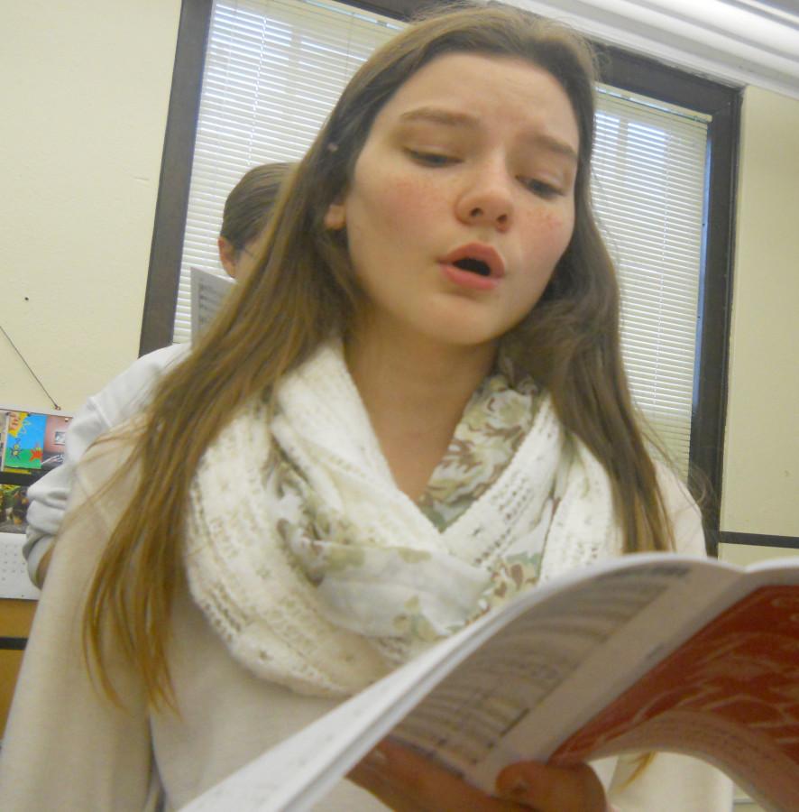 Lily Cosgrove sings to “A la Media Noche” with the rest of the class in the choir room. “I really like the size of the ensemble,” Cosgrove said. “It’s a lot smaller than an Acapella choir and we work at a faster pace.” photo by Honour Sollars