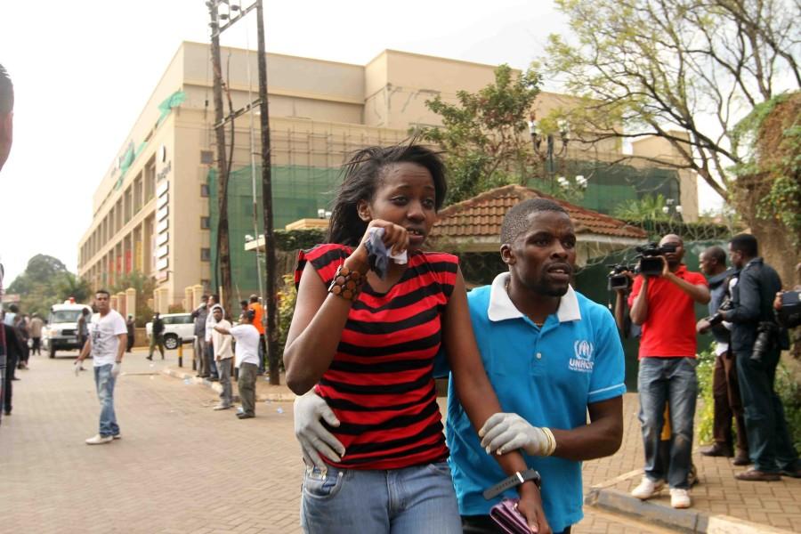 A wounded woman is helped to safety outside Westgate Mall Sept. 21 in Nairobi, Kenya. A gun battle inside the shopping center left several people dead after gunmen attacked one of the citys most exclusive malls. photo courtesy of MCT Campus