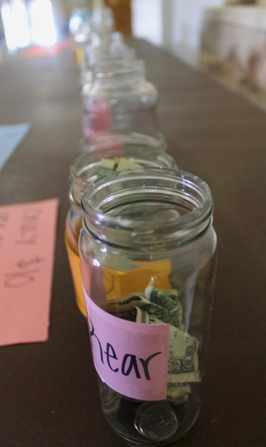 Fundraising jars sit in a line in the lobby of Donnelly Hall Jan. 8. photo by Madi Winfield