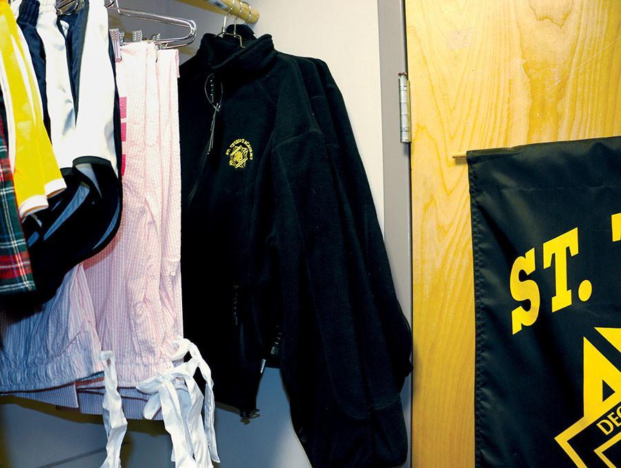 An STA uniform fleece jacket hangs in the Starshop near other apparel. The STA logo embroidered on this jacket was assembled by inmates at Lansing Correctional Facility in Lansing, Kansas. photo by Gloria Cowdin