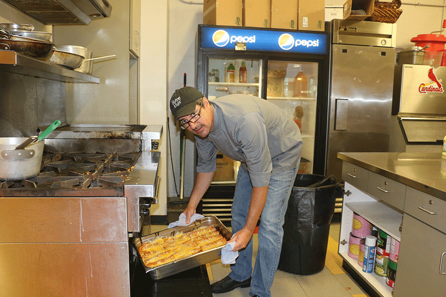 Chef Scott Brake removes  enchiladas from the Bistro Kids oven August 27. photo by Ellie Grever