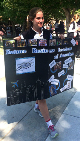 Senior Kay VanAsdale holds a sign for the Future Business Leaders of America at the club fair Aug. 25. photo by Paige Powell