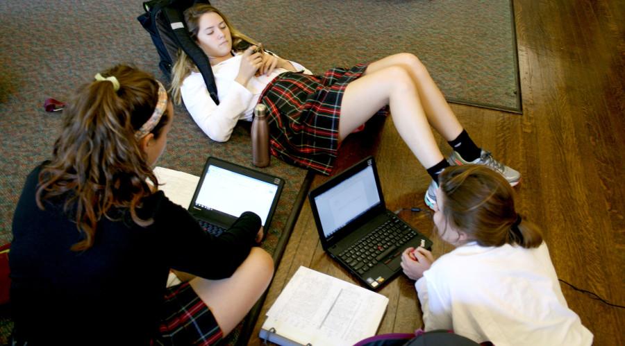 Juniors Rose Madden, Allie McDill and Anna Moore sit on their netbooks and phones during a free period in Mrs. Prentiss’s room. photo by Kate Scofield