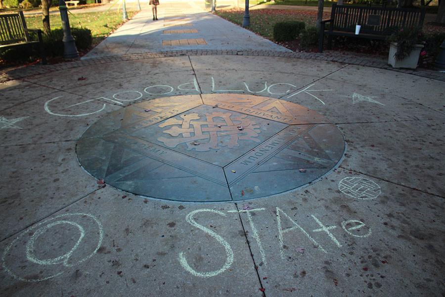 The words Good Luck at State, written in chalk, surround the seal in the Quad. photo by Mary Hilliard