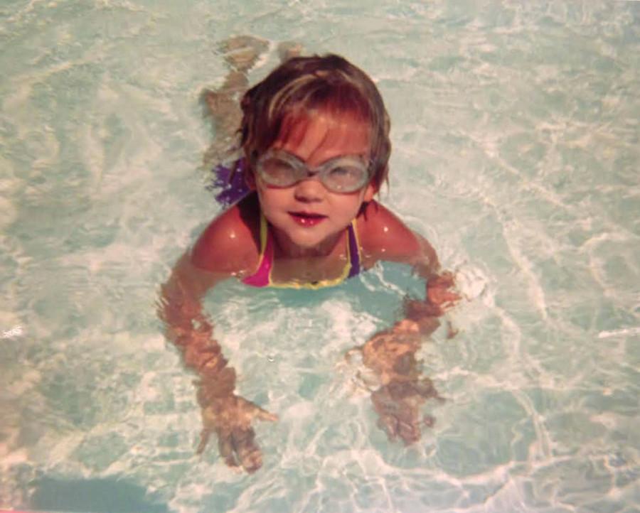 Andie Round poses for a picture in the pool as a young swimmer. Round has committed to swim at Pepperdine University. photo courtesy of Andie Round