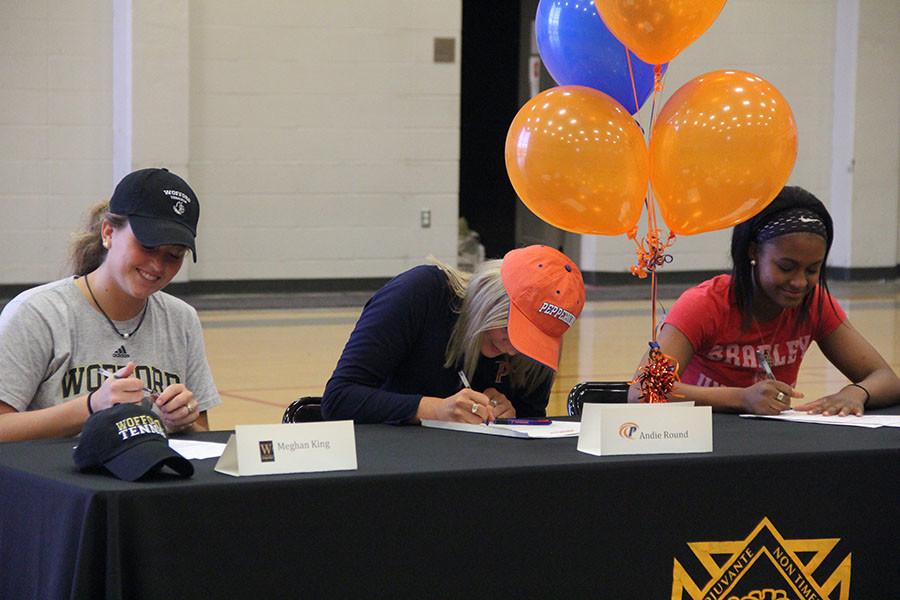 Seniors Meghan King, Andie Round, and Ryan Wilkins sign their letters of intent. Nov. 11 was the first date athletes could officially commit to play collegiate sports. photo by Libby Hutchinson