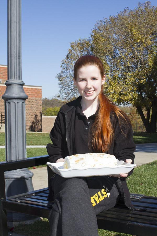 Isabel Fitzpatrick sits in the quad with a cake she made herself. Fitzpatrick is a pastry chef at Andres. photo by Kate Scofield