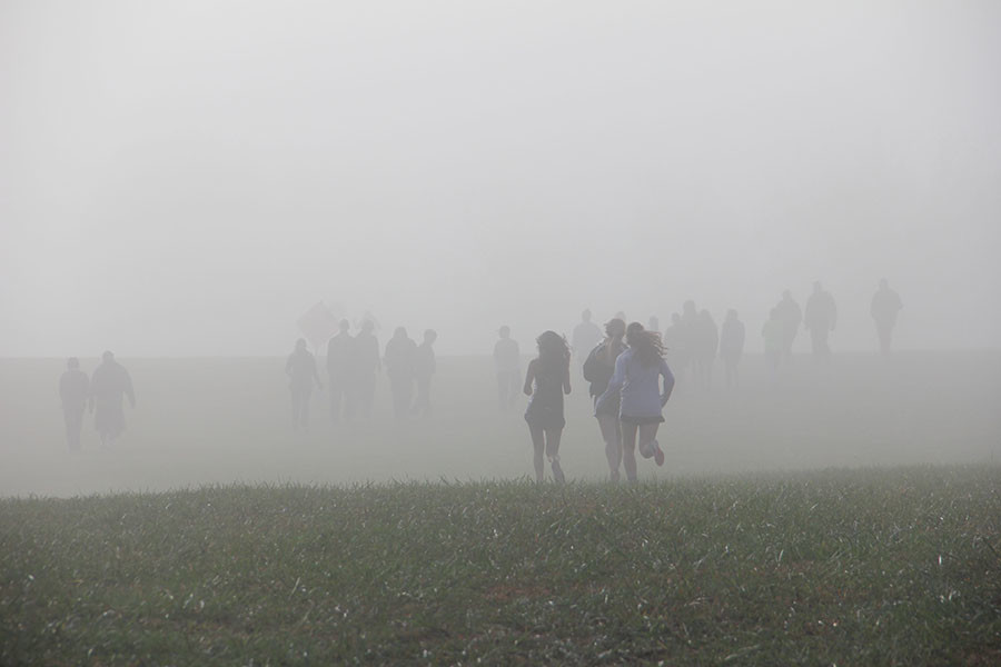 Members of the STA cross country team run to the start line at the Kearney meet Oct. 10. The morning of the race was foggy, but as the temperature rose the fog cleared. photo by Anna Hafner
