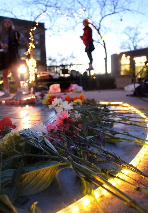 STA students gathered before school Wednesday Dec. 9 in honor of the two year anniversary of the death of STA alumna Becca Lueke. Flowers and pictures were placed on the seal in remembrance. photo by Kat Mediavilla