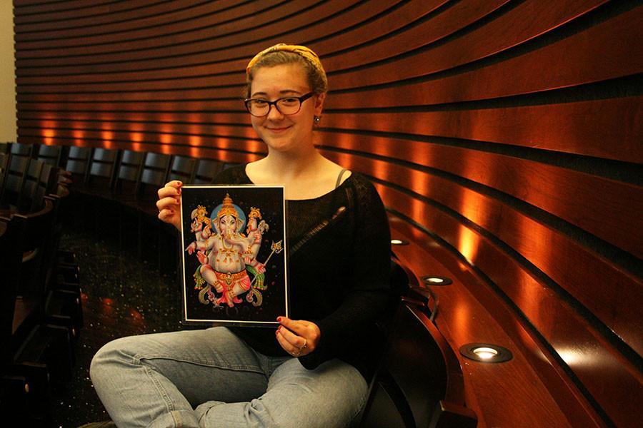Senior Amber Brownlee shows a picture of the Hindu god, Ganesh. Brownlee recalled growing up around pictures of Hindu gods and Hindu storybooks, but had never actually practed Hinduism. photo by Cassie Hayes