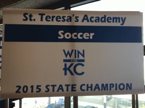 St. Teresas soccer team received a banner to hold during the walk of champions. photo by Katie Donnellan