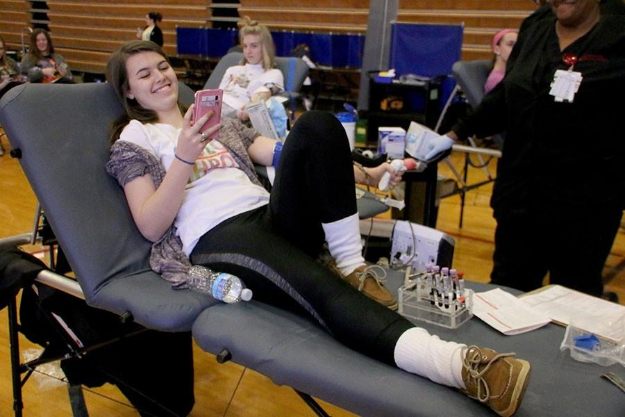 Senior Maggie Oneil smiles while giving blood at STAs annual blood drive on Friday, February12 in the Gym. photo by Kate Scofield