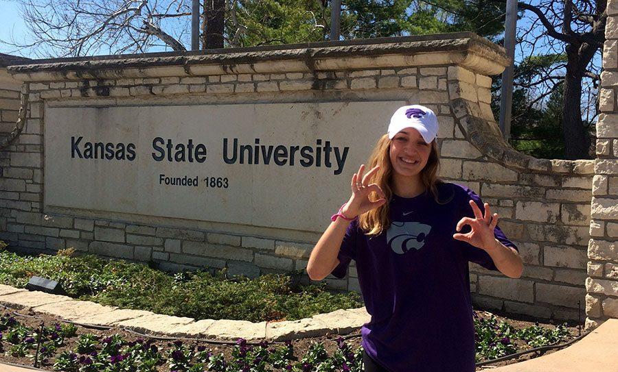 Junior Jacque Smith poses in her new K-State gear in front of her new colleges sign. photo courtesy of Jacque Smith