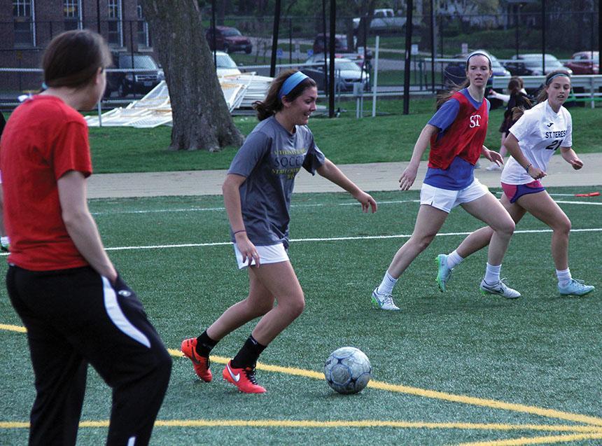 Junior Macy Trujillo dribbles the ball towards the goal during varsity soccer practice March 30. photo by Maggie Knox