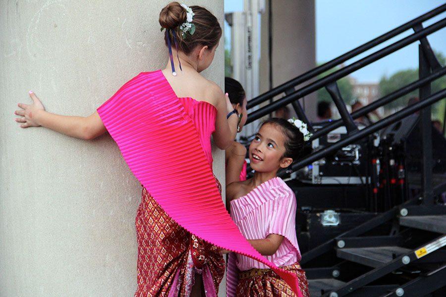 Young dancers laugh and play behind stage before they perform at the Ethnic Enrichment Festival Friday Augst 19, 2016. Almost every culture or country was represented by a performance. Photo by Helen Krause
