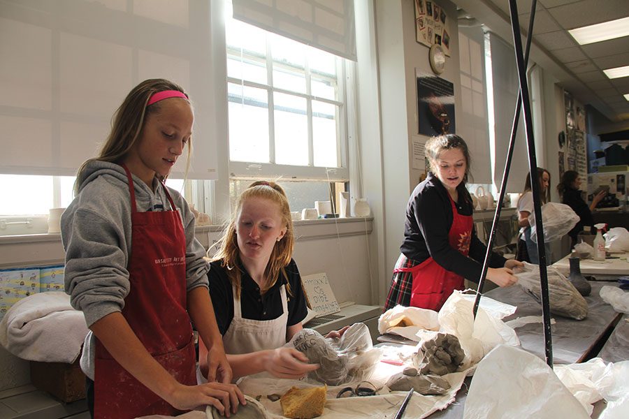 Freshmen ____ ______, from left, Grace Decker and _____ ______ work on their sculptures for 3D Sculpture and Design. This freshman class is taught by art teacher Lisa Dibble. photo by Linden OBrien-Williams