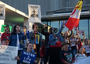 Protestors of the Dakota Access Pipeline chant in front of the Richard Bolling Federal Building Nov. 15. During the protest, people used a megaphone to chant, sing songs and pray. photo by Gabby Martinez