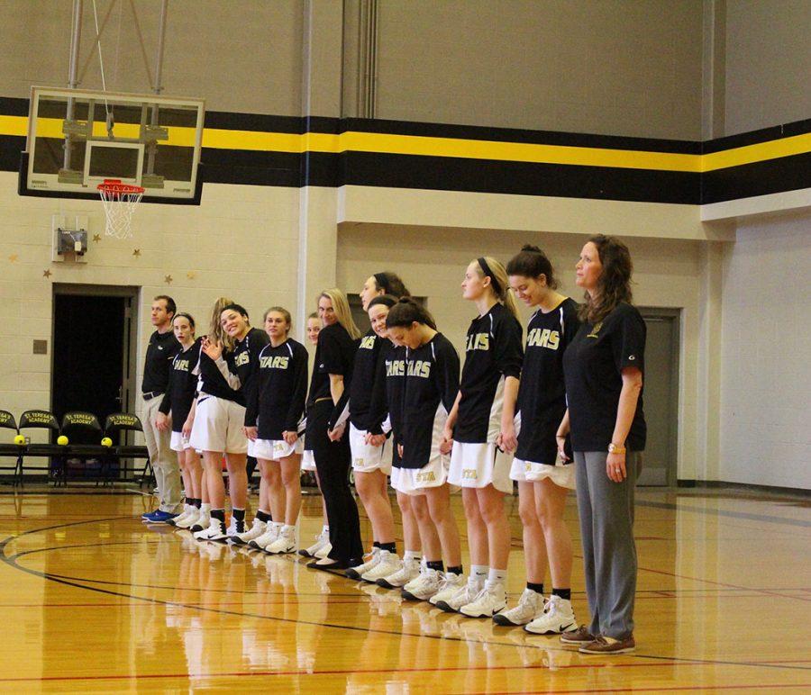 The+Varisity+basketball+team+stands+in+line+for+The+National+Anthem.+photo+courtesy+of+Olivia+Woodbury