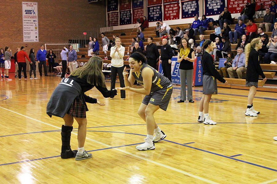 Sophomore Lily Farkas, left, and sophomore Hailey Coleman, right, perform their handshake during the pre-game walk out. The STA Stars took on the Miege Stags Tuesday January 17, 2016.