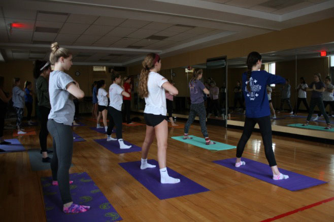 A group of students practice yoga during their double period of the class on Feb. 14th. The class is taught by yoga instructor Andrea Skowronek. photo by Cece Curran