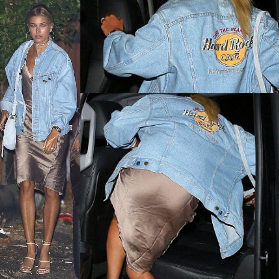 Pictured is Hailey Baldwin wearing a slip dress with a jean jacket layered on top. 