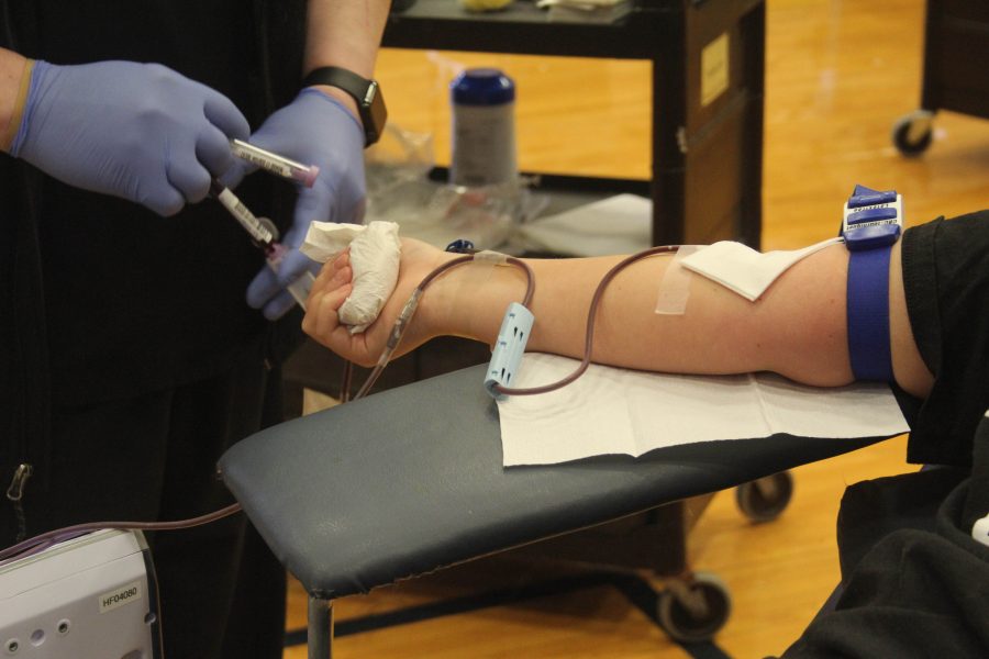 Junior Orion Martinek-Ballard donates her blood Mar. 31 during the STA Blood Drive. photo by Gabby Staker