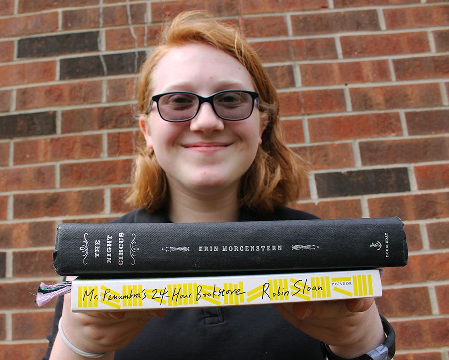 Junior Charlotte Sturr holds the two books she is currently reading on Mar.22. Sturr tries to read one to two books per month. photo by Meghan Baker