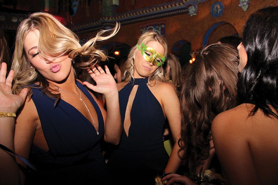 Senior Sophie Cuda, left, dances with seniors Allie McDill and Meg Duffy at prom Apr. 7. McDill was wearing a mask because the theme for prom was masquerade. photo by Anna Louise Sih