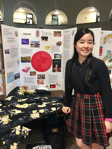 Maya Inoue poses for a picture with her poster board on Japan. photo by Isabel Shorter
