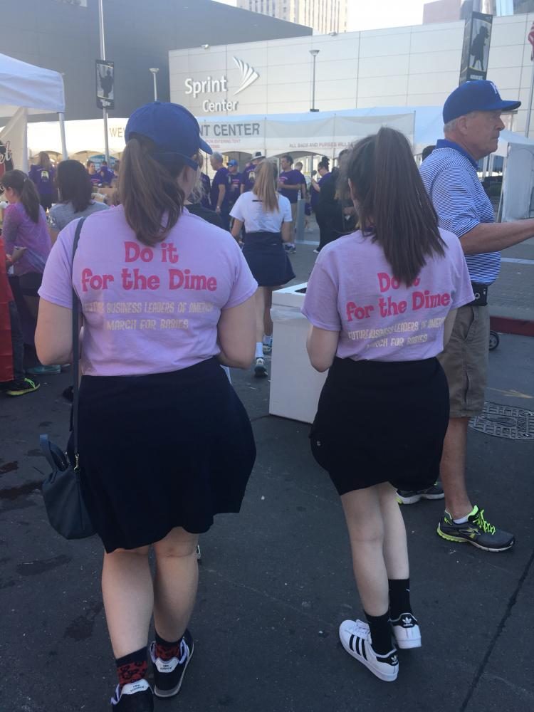 Juniors Maureen Egan and Taylor Staves walk along the route of the march sporting FBLA March of Dimes T-shirts. Photo by Gabby Mesa. 