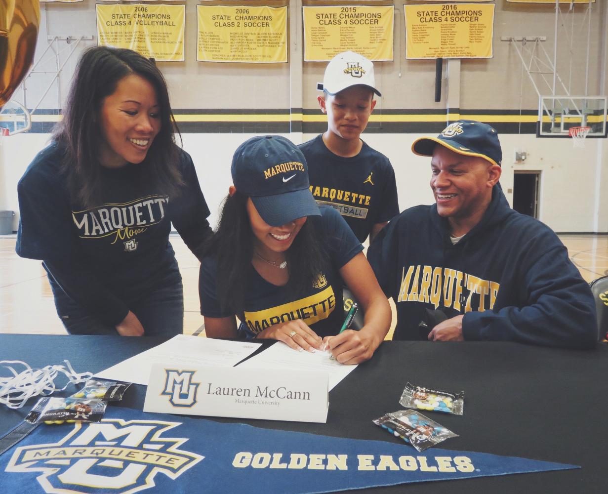 Senior Lauren McCann surounded by her family as she signs to Marquette University. Photo courtesy of Lauren McCann