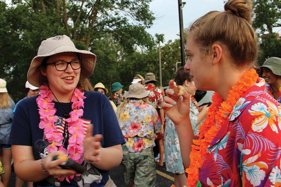 Senior Courtney Talken, left, talks to senior Claire Witt during the senior tailgate Aug. 18. The tailgate was organized and held for the seniors, and took place before school began. photo by Anna Louise Sih