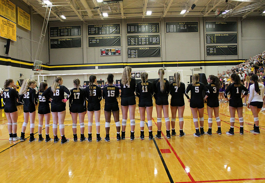 STAs varsity volleyball team lines up for the Pledge of Allegiance and National Anthem at St. Teresas Academy Sep. 13. St. Teresa’s beat Sion after three sets. photo by Meghan Baker