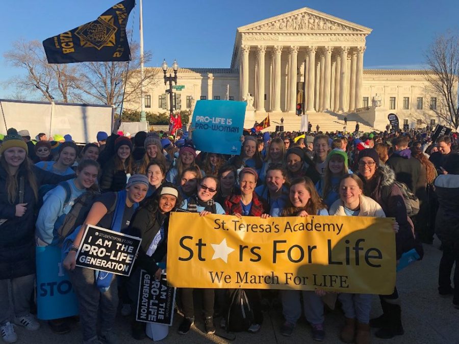 22 members of Stars for Life, a local chapter of Students for Life, stand in front of the Supreme Court building after the March for Life Jan. 19. photo courtesy of Andrea Essner