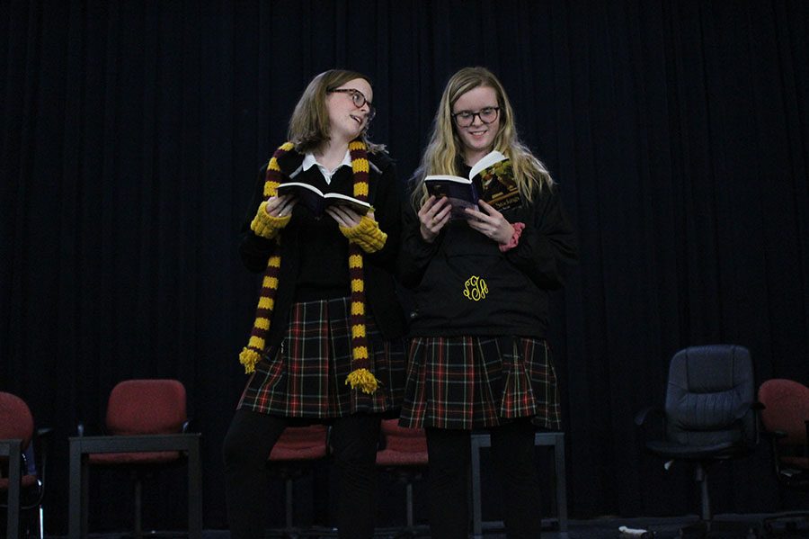 Seniors Maura Graham, left, and Bridget Graham practice lines together before rehearsal Jan. 23. They are playing the same character in the winter play Blue Stockings. photo by Madeline Loehr