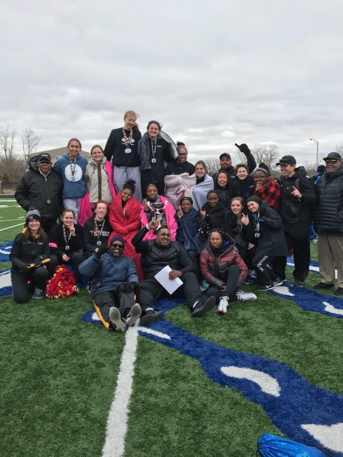 Some of the track team poses for a picture with the first place trophy on the field at the F.L. Schlagle stadium after the meet March 24. The stars won first place with a score of 282 points. photo courtesy of Maddie Douglass