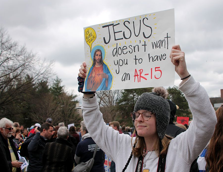 Senior Maura Graham holds up her sign at the March for our Lives in Theis Park March 24. Graham attended the march along with other students and teachers. photo by Meghan Baker

