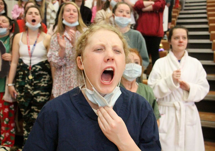Senior Mary Kate Armstrong screams during the Sion vs. STA game at St. Teresas Academy Feb. 24. Armstrong dressed as a doctor because the games theme was chicken pox. photo by Meghan Baker