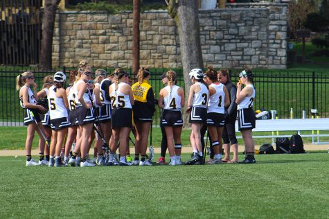 The St. Teresas varsity lacrosse team gathers during a time out called by Aquinas. The Stars won with a score of 18 to 1. photo by Lucy Hoop 
