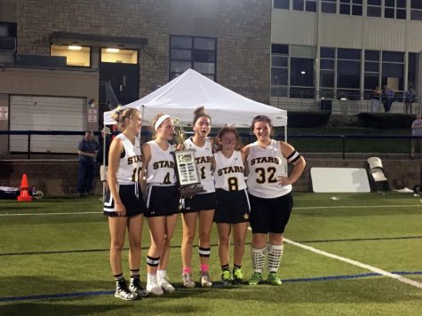 Senior lacrosse players pose with their trophy after the game May 10. photo by Olivia Wirtz