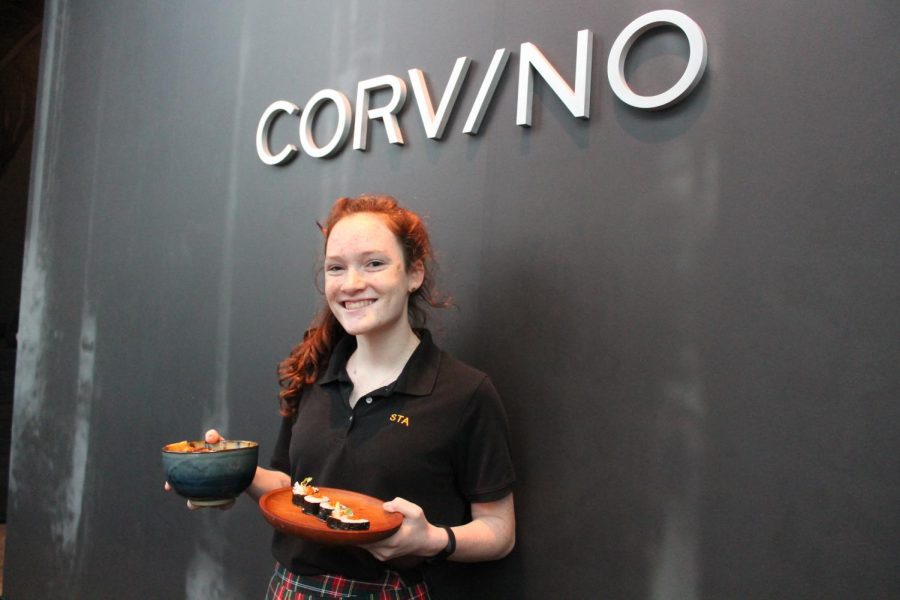 Junior Brooke Eldridge holds two dishes at her mom and stepdads restaurant, Corvino Supper Club and Tasting Room. photo by Meghan Baker