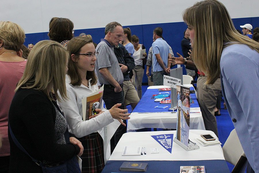 Senior Lauren Daugherty and her mother talk to a college representative, Sep. 13. There were over 130 colleges and universities in attendance. photo by Maggie Hart.