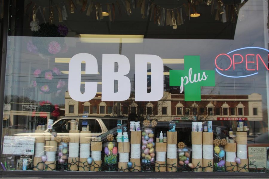 Various products and Easter decorations line the window of CBD+ April 6. CBD can be used for such issues as pain, inflammation, anxiety and depression. photo by Mary Massman.