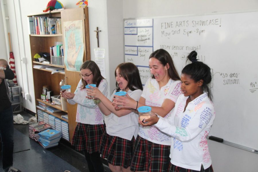 Seniors Lauren Daugherty from left, Megan Gallagher, Grace Berghoff, and Erris Pierson get beta fish from their advisory May 3. Daughtery, Bergoff, and Pierson are in the Meyer advisory. photo by Tess Jones