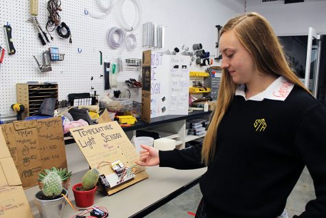 Senior Macy Bauers explains her project for an engineering class May 2. Bauers is one of the seniors who received their STEM certificate this year. photo by Carmon Baker 