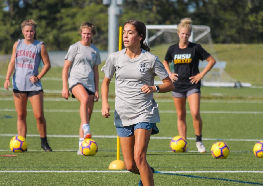 Senior Mollie Plas runs toward a soccer ball pass from her teammate as KC Athletics ECNL 01 players watch Aug. 29. Plas feels empowered by the movement towards equal pay for women in sports. photo by Amy Schaffer