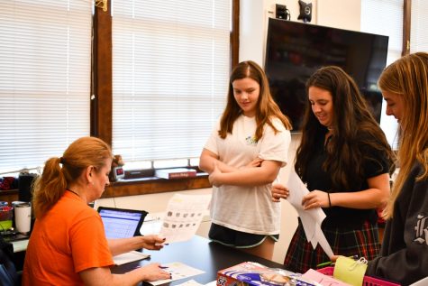 Sophomores Maddison Faul and Kathyrn Hart receive help from Mrs. Blake Sept. 24. In a flipped classroom, students do most of the lecture-based work outside of class and then ask questions during the school day. photo by Lily Sage
