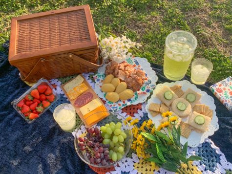 Bouquets of flowers are laid around the picnic spread April 4. The fresh flowers and warm weather of spring can be enjoyed at a picnic.