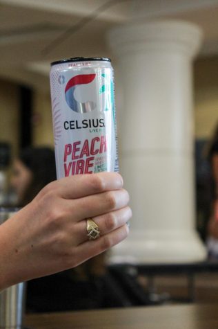 Senior Nina Burke holds a Celsius Sept. 7. This drink, though very popular, is controversial due to the abundance of unknown ingredients. photo by Katie Massman